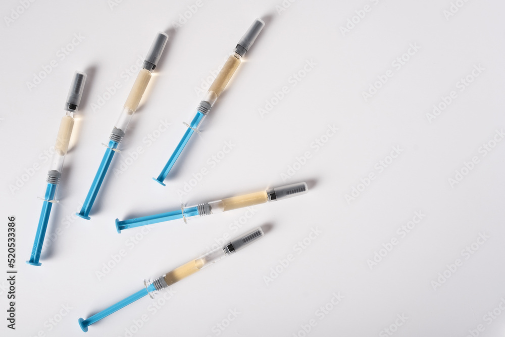 Five syringes with medicine for injection lie on a white background Five syringes with medicine for injection lie on a white background