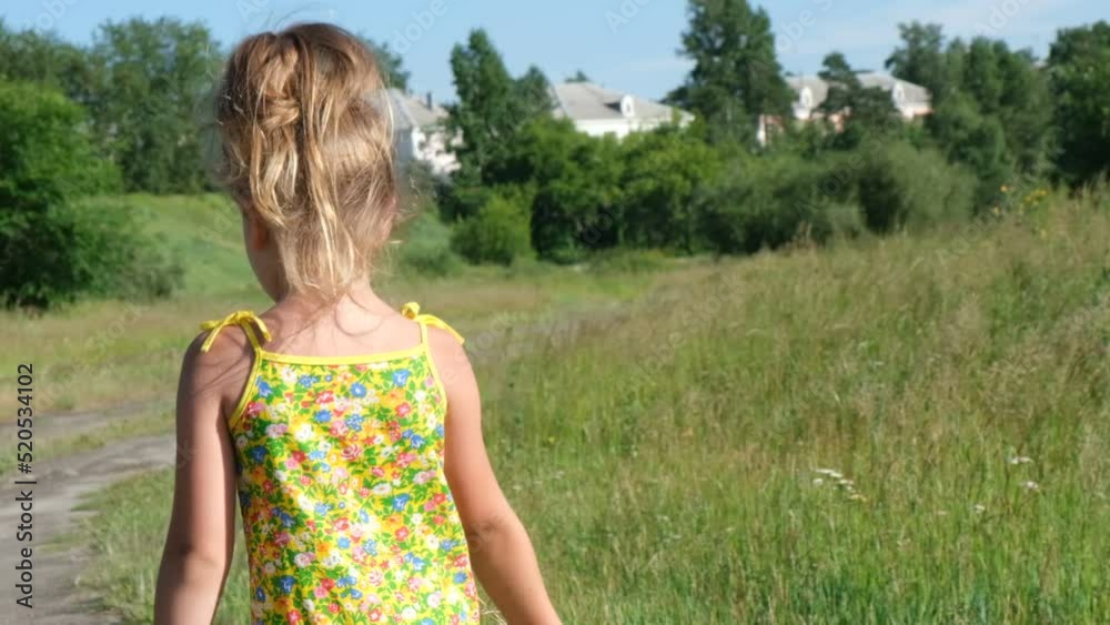 Little girl walking with autumn bouquet in the field. Happy child enjoying nature outdoors. 