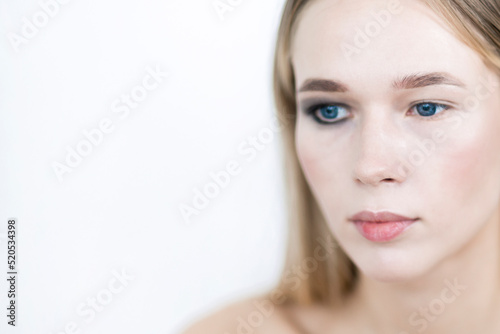 Portrait of a girl with one eye makeup. Close-up.