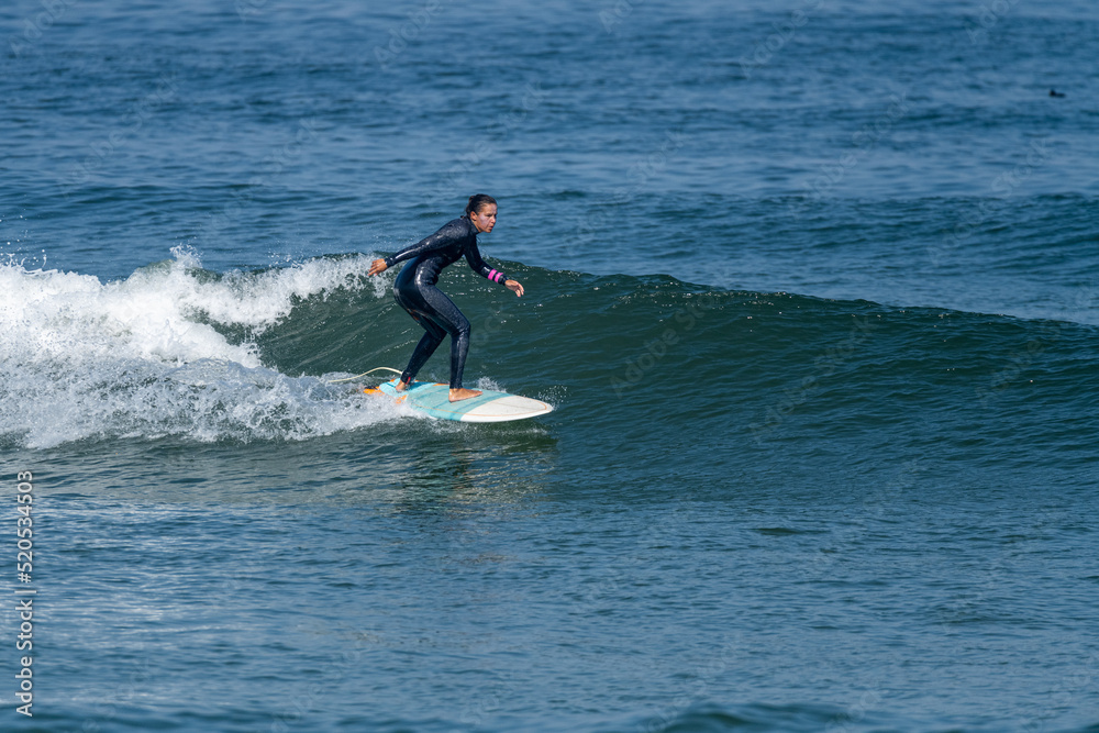 Surfer girl riding a wave