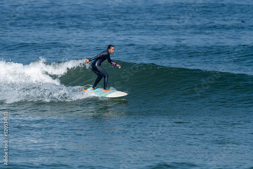 Surfer girl riding a wave © homydesign