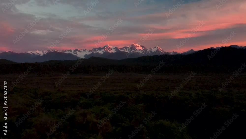 Southern Alps, New Zealand - Aerial view of mountain range and dawn colorful sky, natural scenic landscape. Southern Alps, New Zealand - Aerial view of mountain range and dawn colorful sky, natural scenic landscape.