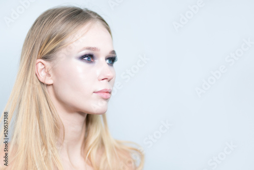 Portrait of a blond girl with beautiful make up isolated on white background.