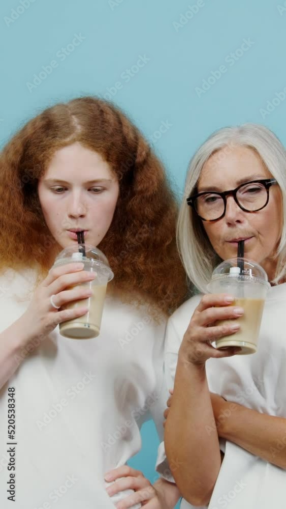 An adult woman and a young girl are drinking cocktails, laughing and talkin An adult woman and a young girl are drinking cocktails, laughing and talkin