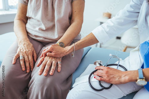 Cropped shot of a female doctor hold her senior patient s hand. Giving Support. Doctor helping old patient with Alzheimer s disease. Female carer holding hands of senior woman.
