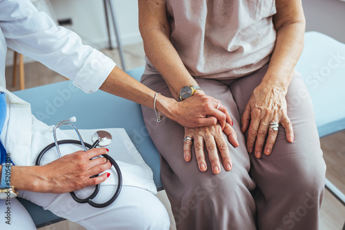 Obraz na plátně Cropped shot of a female doctor hold her senior patient's hand