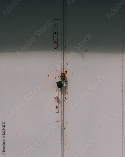 Broken padlock on metal door