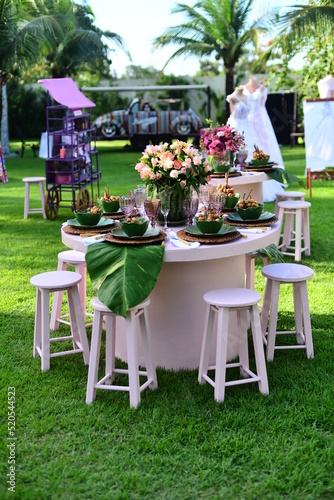 table and chairs in a garden, ornamental flowers