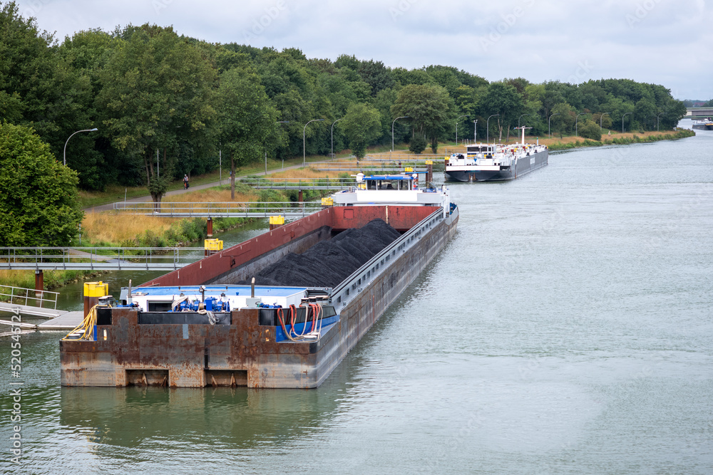 Inland vessel moored to a canal Inland vessel moored to a canal