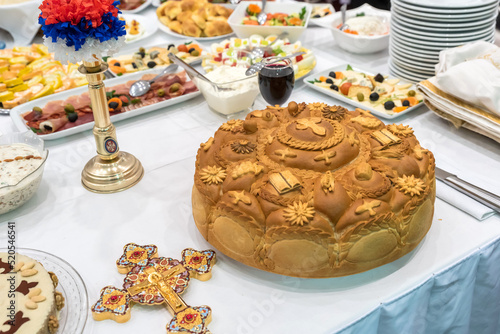 Christian ortodox bread on traditional ortodox ceremony table photo