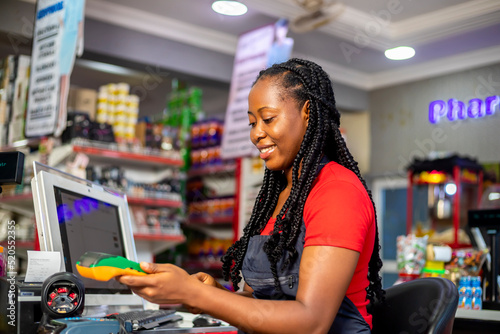 Photography Closeup of a customer using her credit card to pay for goods brought from superm