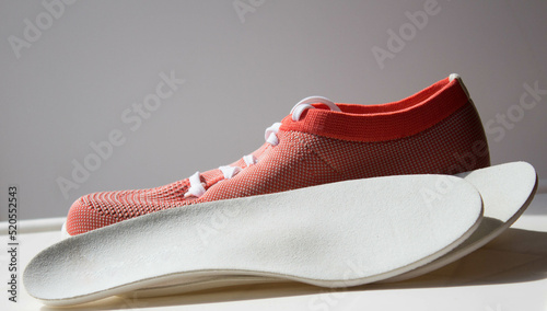 Leather orthopedic insoles located near the sport shoe with orth
