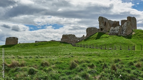 View of ruins of Duffus Castle located in green valley on grassy hill near Elgin Moray, Scotland photo