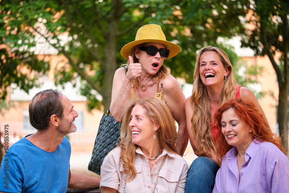 Portrait of five mature adults having in a park. Portrait of five mature adults having in a park.