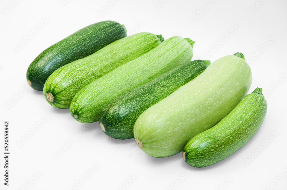 fresh zucchini on a white background. delicious green vegetables on the table. appetizing zucchini on a light texture. healthy food concept fresh zucchini on a white background. delicious green vegetables on the table. appetizing zucchini on a light texture. healthy food concept