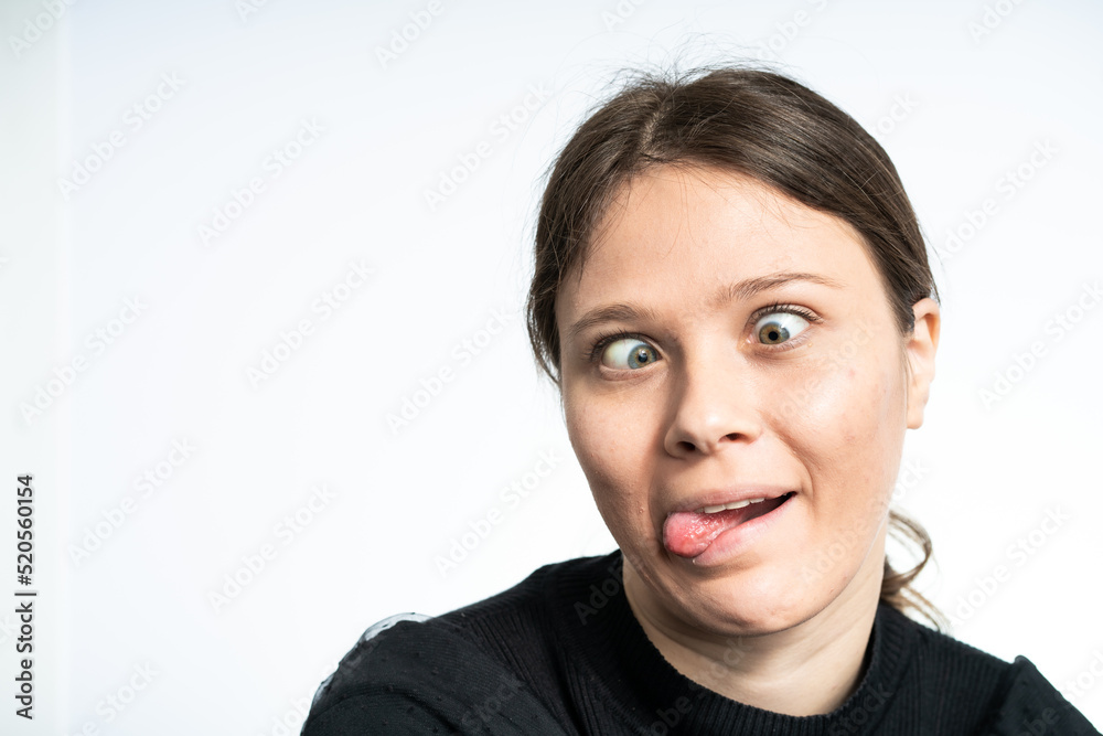 Happy Young woman making funny faces, wearing black Happy Young woman making funny faces, wearing black