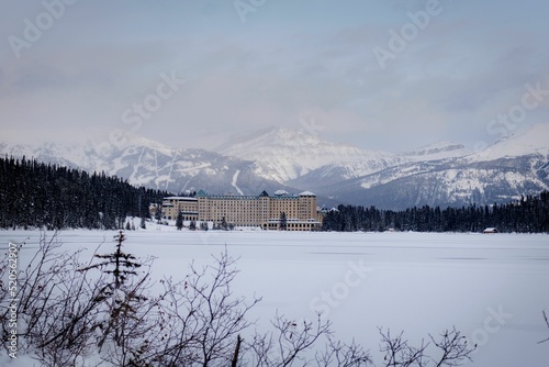 Beautiful shot of the Fairmont Chateau Lake Louise in winter with mountains in the background photo