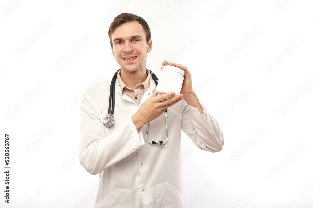 Portrait of a doctor in white medical coat showing an empty jar isolated on white background with copy space Portrait of a doctor in white medical coat showing an empty jar isolated on white background with copy space