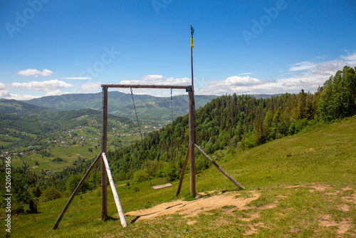Swing on the edge of a mountain cliff in the Carpathians