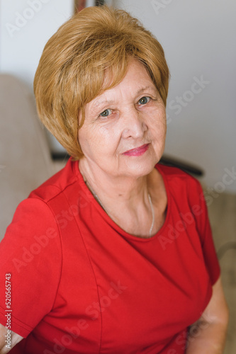 portrait of smiling elderly woman in red t-shirt