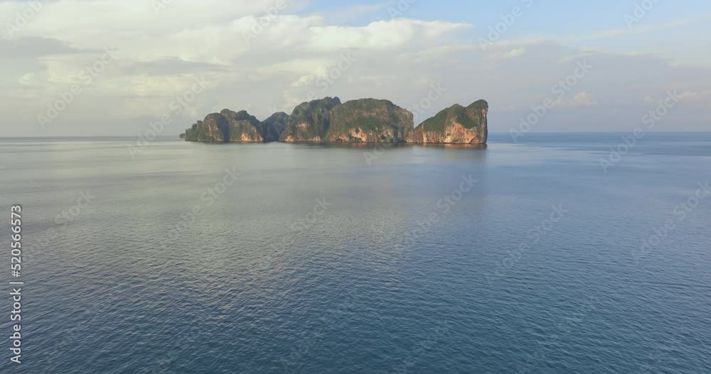 Aerial drone flying above the ocean surface heading to PhiPhi island with beautiful blue turquoise seawater. Tropical Landscape of sea and waves in summer holiday. Travel landmark of Krabi, Thailand. Aerial drone flying above the ocean surface heading to PhiPhi island with beautiful blue turquoise seawater. Tropical Landscape of sea and waves in summer holiday. Travel landmark of Krabi, Thailand.