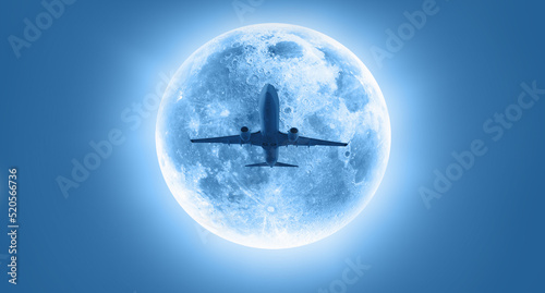 Silhouette of a passenger plane passing in front of the full moon "Elements of this image furnished by NASA "