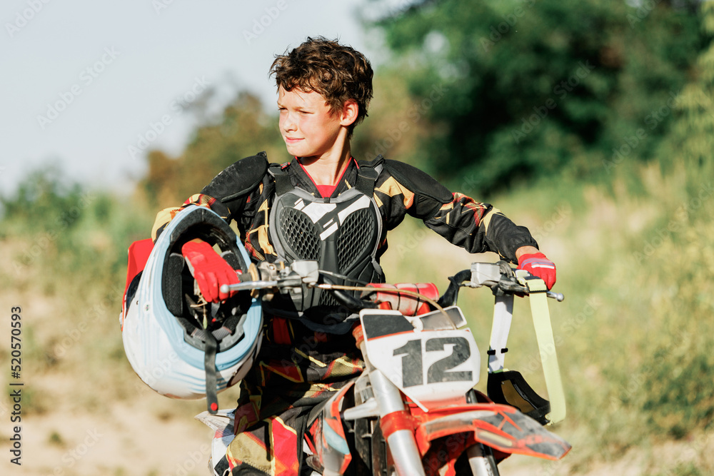 Live shot of junior sportsman motorcyclist training on motorbike at hot summer day outdoors. Motocross rider in action. Motocross sport challenges Stock Photo Adobe Stock
