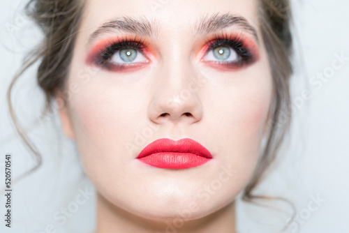Portrait of a beautiful girl with bright makeup close-up. Look up.