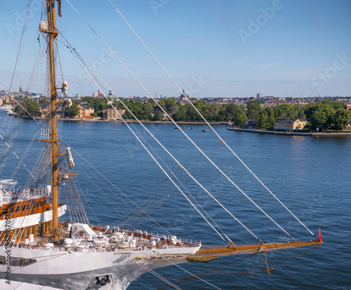 Fore with bowsprit of cruise sailing ship and skyline of the old town Gamla Stan, a sunny summer day in Stockholm