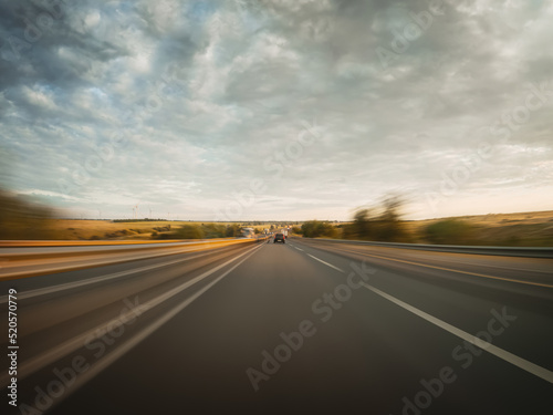 Front view from the moving car to the countryside highway and surrounding landscapes. © railwayfx