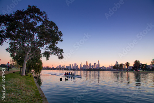 Melbourne city skyline behind Albert Park lake in the pre-dawn light 
