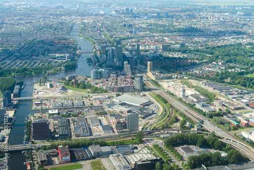 Canvas Print Aerial view from airplane of modern city with buildings, skyscrapers and highways between river