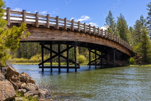 Scenic view of a wooden bridge on Deschutes River in Sunriver, Oregon photo
