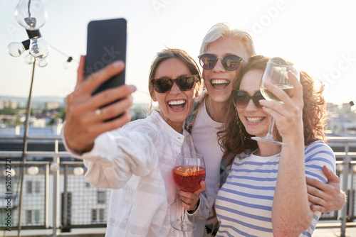Group of friends make a selfie together  in top of the roof