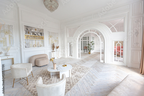 snow-white luxury apartment interior with Egyptian-style decor with light stylish furniture. huge panoramic windows and an archway. minimalism and simplicity with the elegance of modern housing design © 4595886