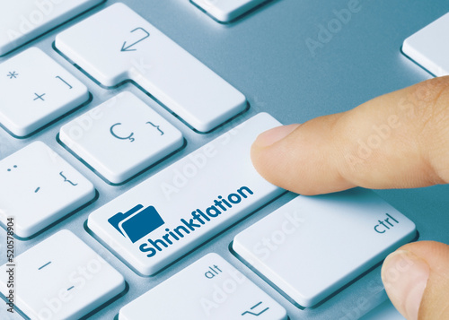 Shrinkflation - Inscription on Blue Keyboard Key.