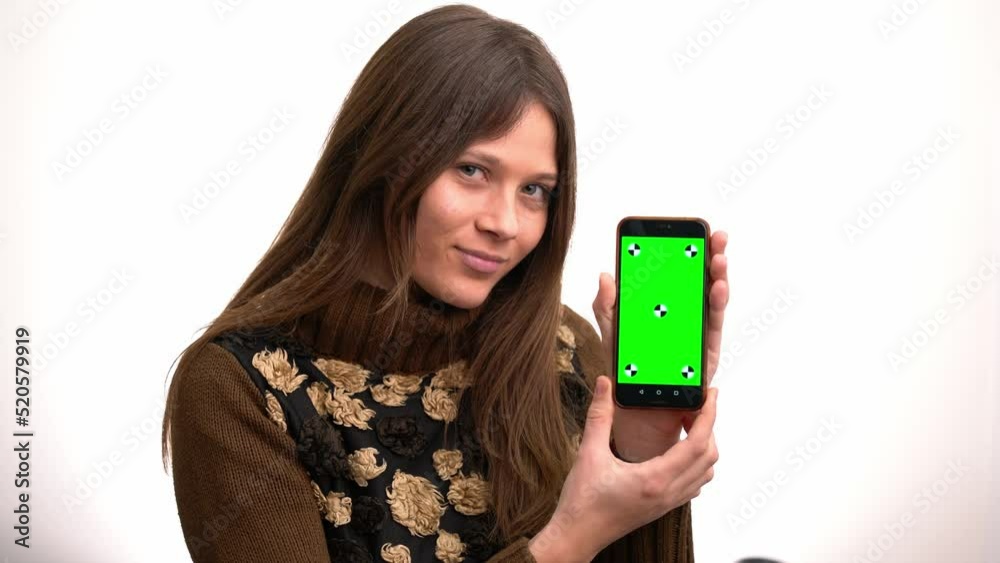 Beautiful young woman using and showing the screen of an smartphone Beautiful young woman using and showing the screen of an smartphone