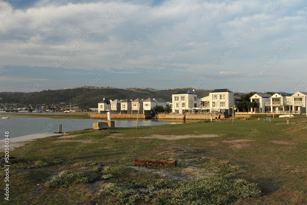 Living close to nature - white houses in Knysna at the seaside under cloudy sky Living close to nature - white houses in Knysna at the seaside under cloudy sky