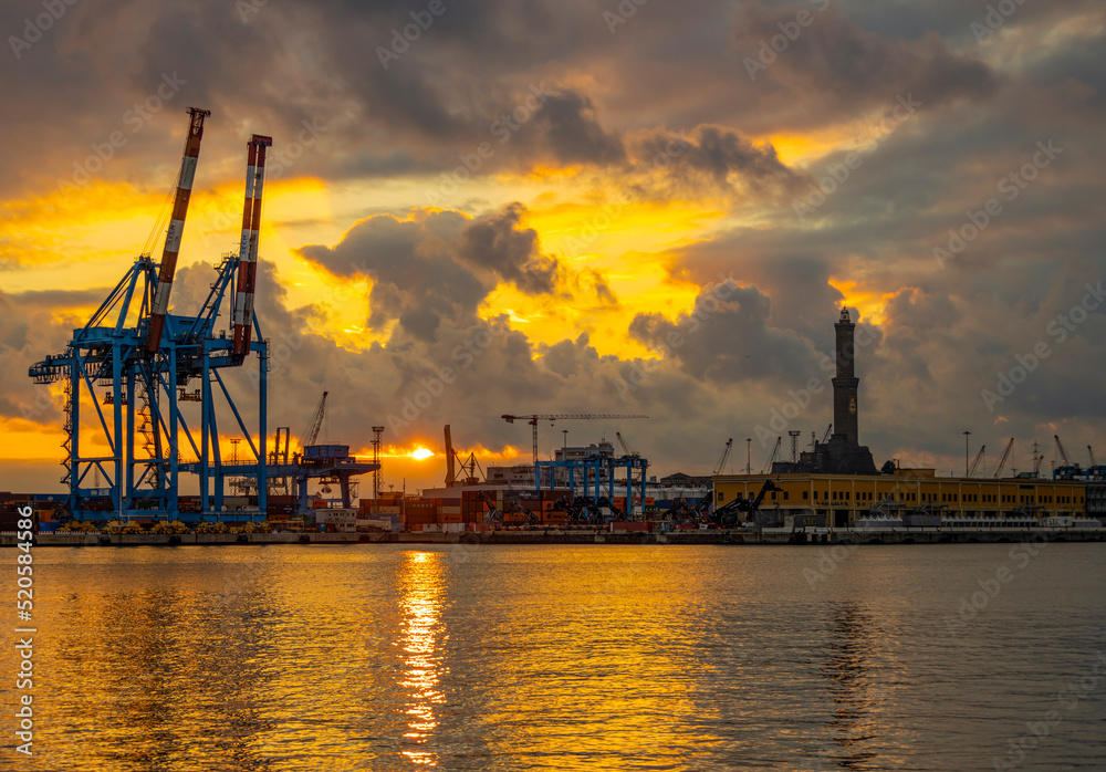 Obraz premium GENOA (GENOVA), ITALY, JANUARY 23, 2022 - View of Lanterna (lighthouse) in the port of the city of Genoa at sunset with cloudy sky, Italy