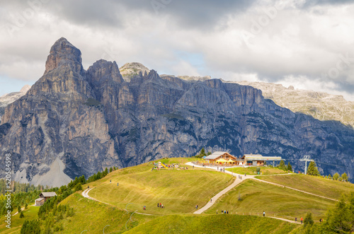 Panoramic view of the Dolomite mountains, Mount Sassongher and the Ütia de Bioch refuge, Bolzano province, Italy.