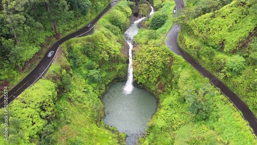 Aerial footage of a waterfall and an asphalt road to Hana in Maui, Hawaii photo