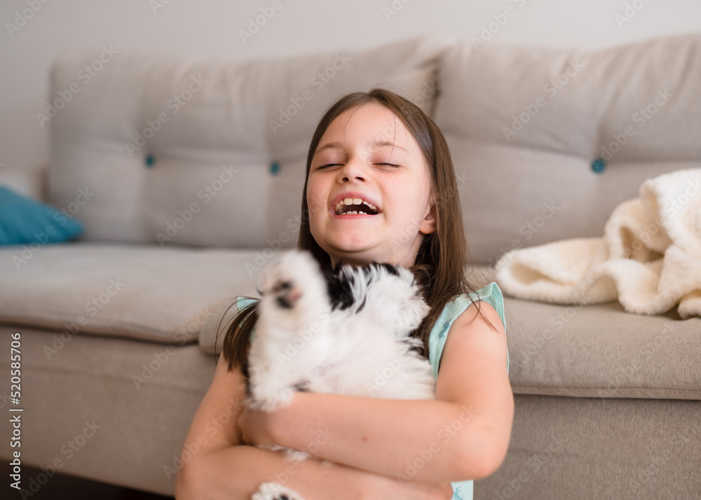 Child with dog at home. Little girl plays with a dog at home. Child and animal. Child with dog at home. Little girl plays with a dog at home. Child and animal.