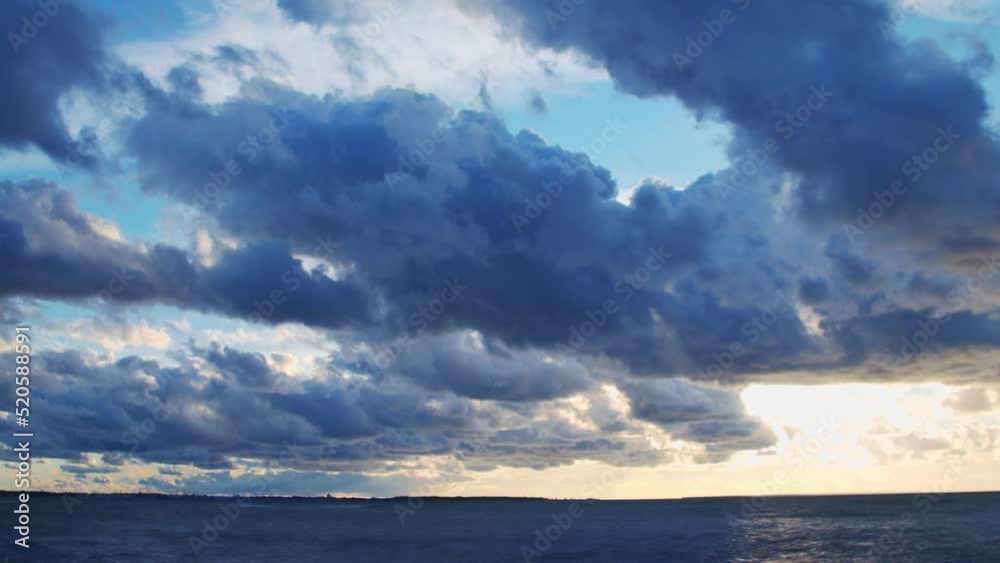 Timelapse with Sunset and Cumulus Clouds Flying High in a Beautiful Blue Sky. Sun Dawn over the Sea. Weather, Climate Change and Global Warming . Timelapse with Sunset and Cumulus Clouds Flying High in a Beautiful Blue Sky. Sun Dawn over the Sea. Weather, Climate Change and Global Warming .