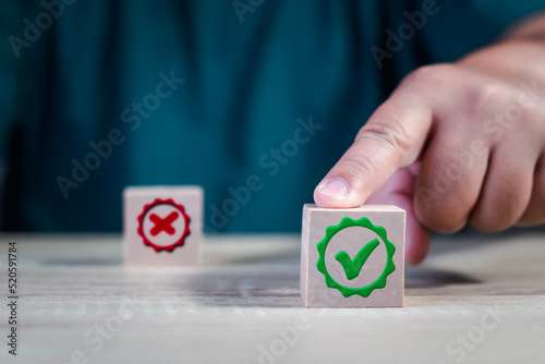 Hand finger point a choice between two cubes with right and wrong