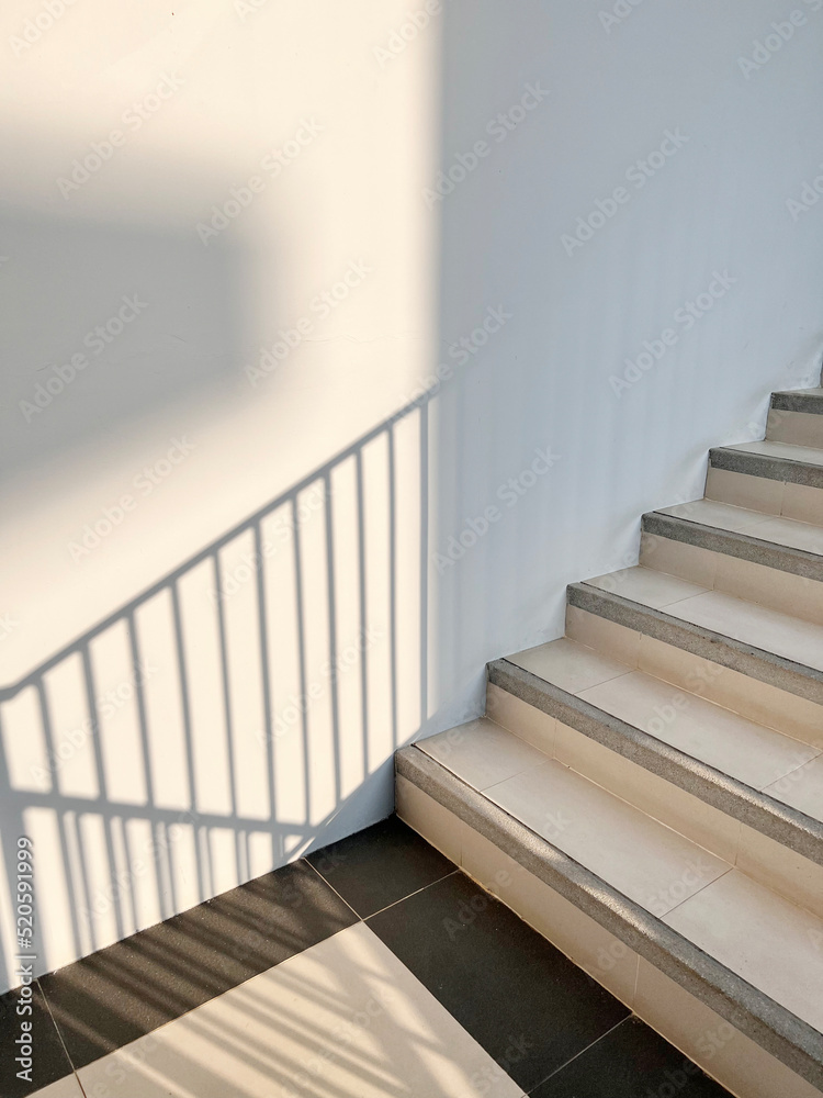Stairs leading up to the building and shadows in the sunlight. Stairs leading up to the building and shadows in the sunlight.