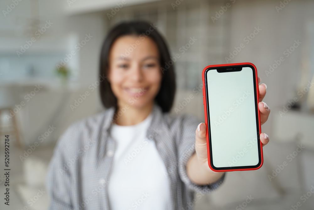 Closeup female hand showing phone with blank mock up screen. Apps advertisement, online store offer