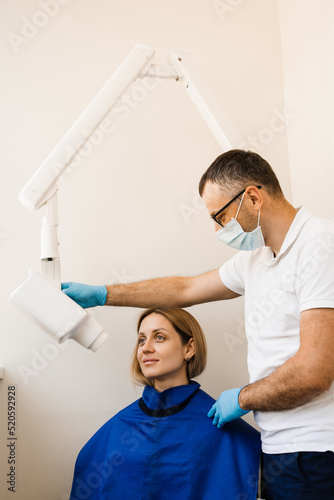 Dentist do x-ray tooth scan for woman in dentistry. Teeth x ray scanning for detect toothache and treat roots.