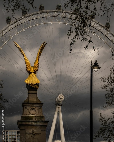 Vertical view of the royal air force memorial before the London eye on a rainy day photo