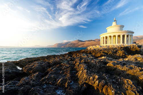 Lighthouse of Saint Theodore on cliffs at sunset, Argostoli, Kefalonia, Ionian Islands, Greek Islands, Greece photo