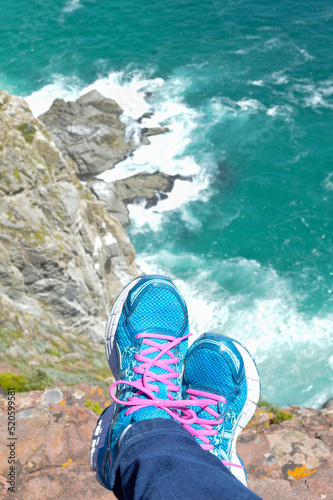feet on the cliff